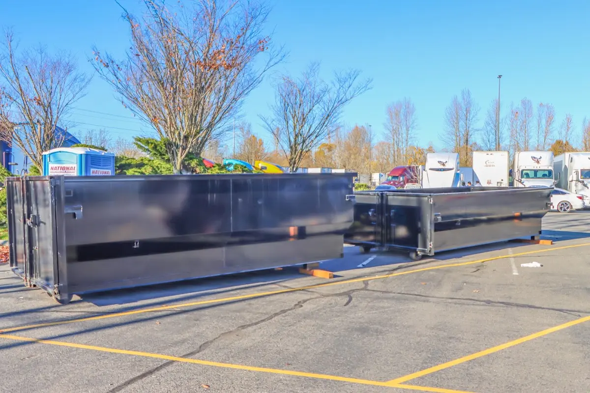 Professional dumpster rental service with roll-off container on residential driveway in Stony Point